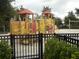 playground with colorful play structures and safety fencing at 5265 Oakbourne Ave, Davenport, FL 33837
