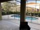 Private screened-in pool with safety fence for children at 5265 Oakbourne Ave, Davenport, FL 33837