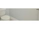 Small bathroom with toilet and light gray walls at 1862 Beach Ridge Rd, Celebration, FL 34747