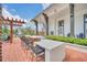 Outdoor kitchen area with built-in grill, counter space, and bar seating at 1862 Beach Ridge Rd, Celebration, FL 34747