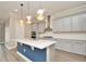 Modern kitchen with gray cabinets, quartz countertops, and an island at 1862 Beach Ridge Rd, Celebration, FL 34747