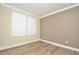 Spacious bedroom with wood-look floors and plantation shutters at 1862 Beach Ridge Rd, Celebration, FL 34747