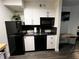 Modern kitchen with black and white appliances at 3100 Parkway Blvd # 712, Kissimmee, FL 34747