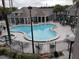 Community pool and spa with surrounding patio furniture at 3100 Parkway Blvd # 712, Kissimmee, FL 34747