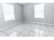 Bright bedroom with tile floors and two windows at 1411 Overdale St, Orlando, FL 32825