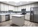 Updated kitchen, featuring stainless steel appliances and an island at 1411 Overdale St, Orlando, FL 32825