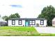 Newly renovated home with a modern exterior, paver driveway, and lawn at 1411 Overdale St, Orlando, FL 32825