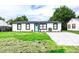 Updated home features a fresh exterior, paver driveway, and spacious lawn at 1411 Overdale St, Orlando, FL 32825