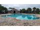 Relaxing community pool with patio and shaded seating areas at 4957 Whistling Wind Ave, Kissimmee, FL 34758