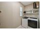 Laundry room with washer, dryer, and shelving at 790 Shady Canyon Way, Poinciana, FL 34759
