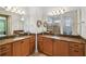 Double vanity bathroom with granite countertops and large mirrors at 790 Shady Canyon Way, Poinciana, FL 34759