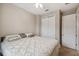 King-size bed in a bedroom with ceiling fan and double door closet at 790 Shady Canyon Way, Poinciana, FL 34759