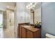 Guest bathroom with brown vanity and large mirror at 790 Shady Canyon Way, Poinciana, FL 34759