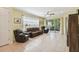 Bright living room featuring tile floors, comfy seating, and access to a screened patio at 790 Shady Canyon Way, Poinciana, FL 34759