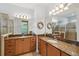 Double vanity bathroom with granite countertops and large mirrors at 790 Shady Canyon Way, Poinciana, FL 34759