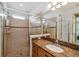 Bathroom with shower, granite countertop, and a single sink at 790 Shady Canyon Way, Poinciana, FL 34759