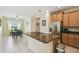 Modern kitchen with granite island, stainless steel appliances, and wood cabinets at 790 Shady Canyon Way, Poinciana, FL 34759