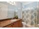 Bathroom with brown vanity, shower/tub combo and floral shower curtain at 790 Shady Canyon Way, Poinciana, FL 34759