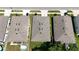 Three houses with gray asphalt shingle roofs at 5569 Oro Valley Rd, Auburndale, FL 33823