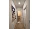Hallway with bathroom access and wall tapestry at 5569 Oro Valley Rd, Auburndale, FL 33823