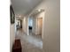 Long hallway with views into other rooms and tile floors at 5569 Oro Valley Rd, Auburndale, FL 33823