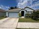 Beautiful light blue house with a two-car garage at 5569 Oro Valley Rd, Auburndale, FL 33823