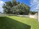 Large backyard with grassy area and privacy fence at 5569 Oro Valley Rd, Auburndale, FL 33823