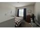 Cozy bedroom with window, dresser, and a bed at 5569 Oro Valley Rd, Auburndale, FL 33823