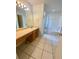 Bathroom with double vanity, tub and tiled floor at 5230 Clarion Oaks Dr, Orlando, FL 32808