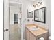 Updated bathroom with vanity and view of living area at 3032 Parkway Blvd # 201, Kissimmee, FL 34747