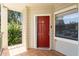 Condo entry with red door and small balcony at 3032 Parkway Blvd # 201, Kissimmee, FL 34747
