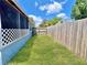 Backyard with wooden fence and screened patio at 1206 Osceola Ave, Tavares, FL 32778