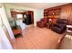 Living room with tiled floors and leather furniture, open to kitchen at 1206 Osceola Ave, Tavares, FL 32778