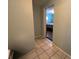 Hallway with light teal walls and view of bedroom at 1206 Osceola Ave, Tavares, FL 32778