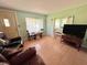 Living area with tiled floors and comfy seating near a large window at 1206 Osceola Ave, Tavares, FL 32778