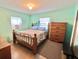 Bedroom with wood bed frame and dresser at 1206 Osceola Ave, Tavares, FL 32778