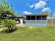 House exterior and backyard with patio and landscaping at 1206 Osceola Ave, Tavares, FL 32778