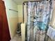 Bathroom with gray toilet and dragonfly shower curtain at 1206 Osceola Ave, Tavares, FL 32778