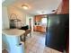 Retro kitchen with wood cabinets and black appliances at 1206 Osceola Ave, Tavares, FL 32778