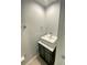 Small bathroom with a single sink and marble vanity top at 5341 Indian Creek Dr # B, Orlando, FL 32811