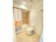 Clean bathroom with floral shower curtain and updated toilet at 5341 Indian Creek Dr # B, Orlando, FL 32811