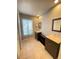 Bathroom boasts double sinks, dark brown vanity, and tile floors at 5341 Indian Creek Dr # B, Orlando, FL 32811
