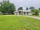 Single story home with large front yard and circular driveway at 1025 W Lake Hamilton Dr, Winter Haven, FL 33881