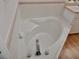 Relaxing corner bathtub with modern fixtures at 1025 W Lake Hamilton Dr, Winter Haven, FL 33881