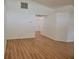 Open living room with light wood floors and neutral walls at 1025 W Lake Hamilton Dr, Winter Haven, FL 33881
