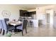 Open concept dining area with kitchen and a marble dining table at 9355 Sommerset Hills Dr # 9355, Davenport, FL 33896
