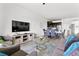 Open living room with gray sofa and adjacent dining and kitchen areas at 9355 Sommerset Hills Dr # 9355, Davenport, FL 33896