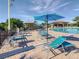 Poolside lounge area with umbrellas and comfortable chairs at 9355 Sommerset Hills Dr # 9355, Davenport, FL 33896