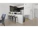 Modern kitchen with dark cabinets, an island, and stainless steel appliances at 9355 Sommerset Hills Dr # 9355, Davenport, FL 33896