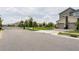View of a gated community entrance with townhouses, showing the neighborhood's security and style at 9355 Sommerset Hills Dr # 9355, Davenport, FL 33896